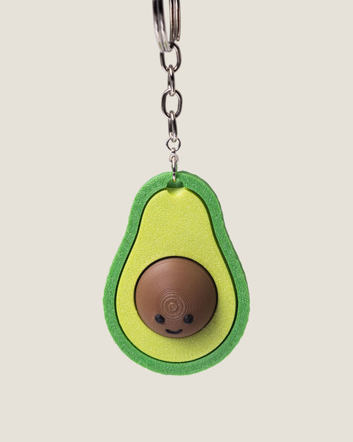 3D printed avocado clicker keychain with a smiling seed