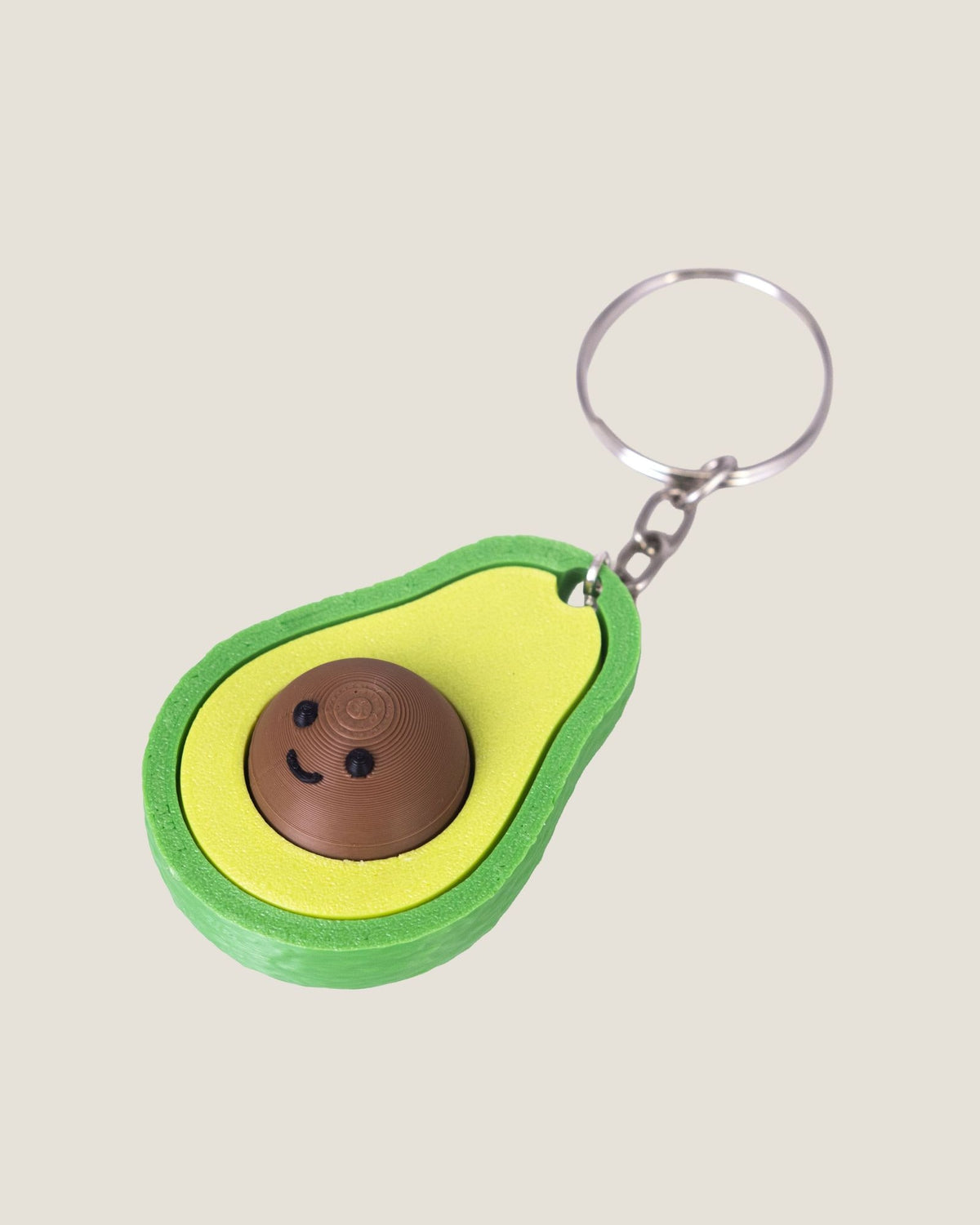 3D printed avocado clicker keychain with a smiling seed