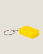 3D printed bubble pop clicker keychains in pink, yellow and blue