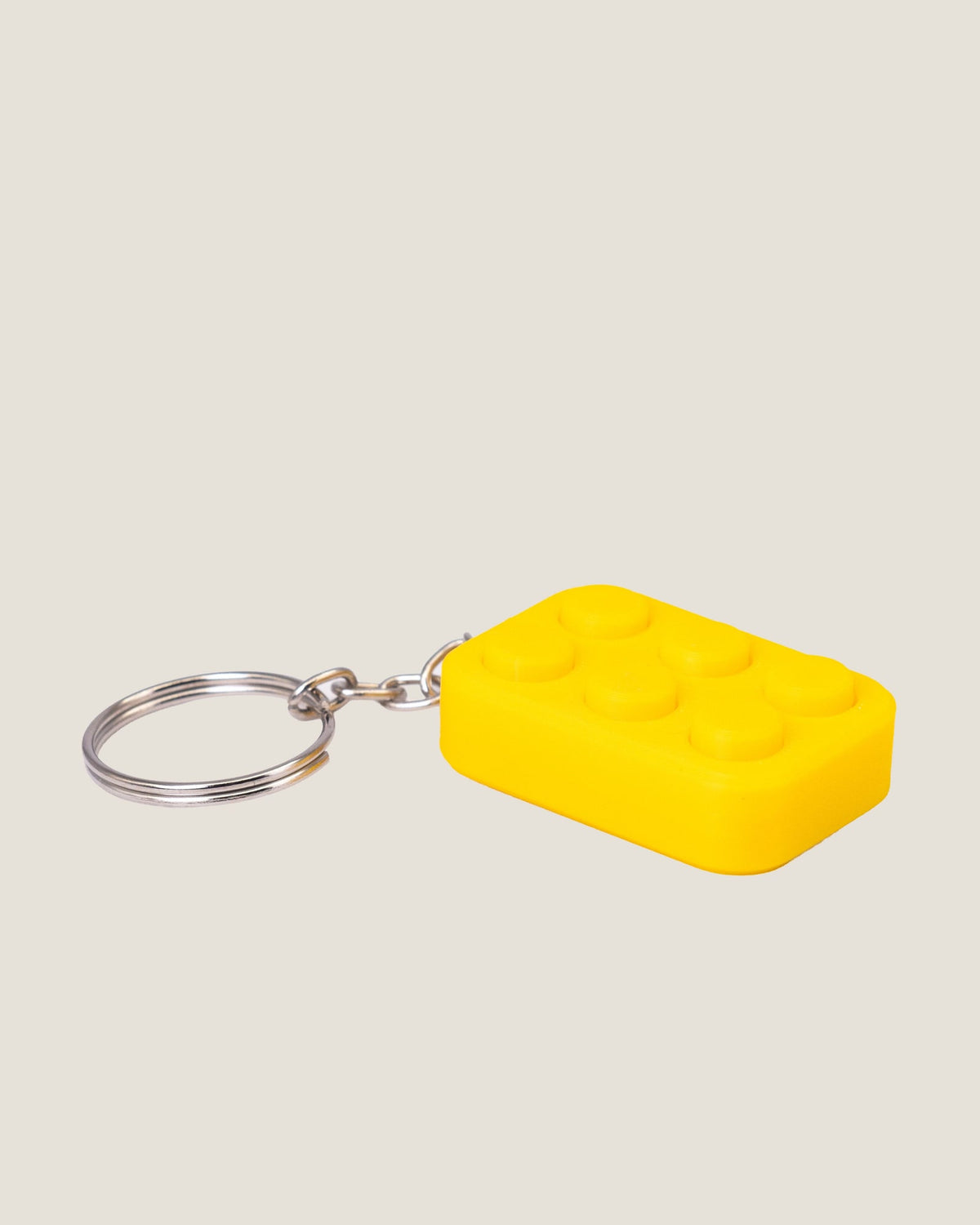 3D printed bubble pop clicker keychains in pink, yellow and blue