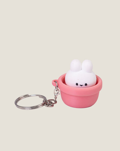 3D printed bunny in a pot clicker keychains in pink and green
