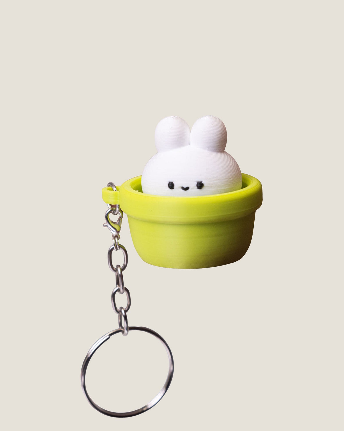 3D printed bunny in a pot clicker keychains in pink and green