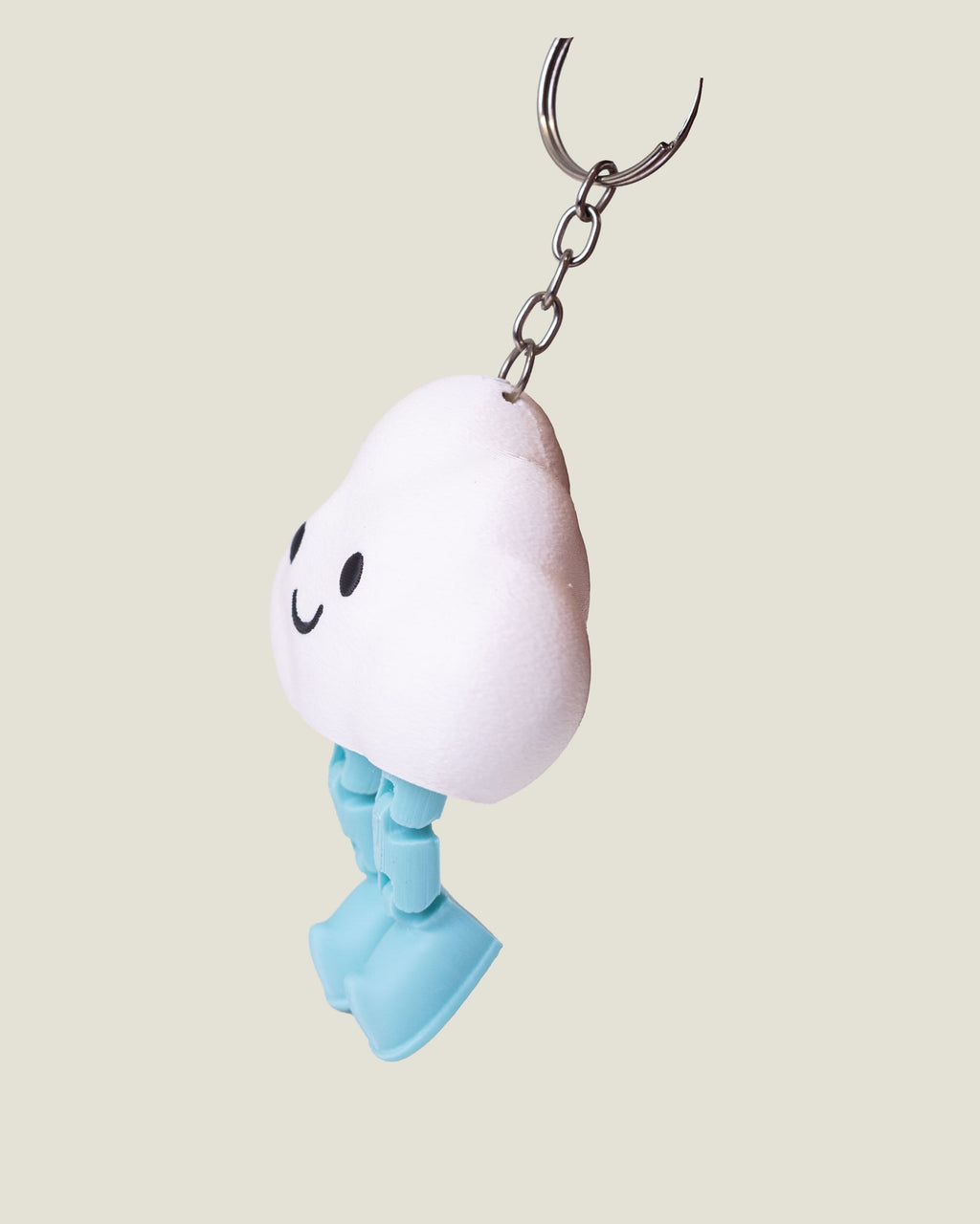 3D printed smiling cloud keychain with jiggly jointed legs