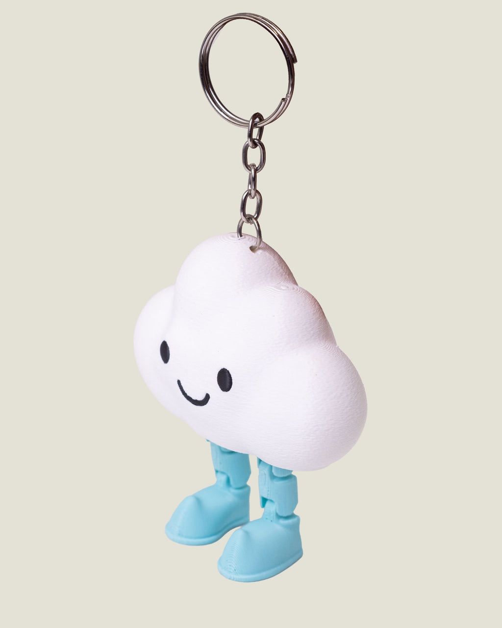 3D printed smiling cloud keychain with jiggly jointed legs