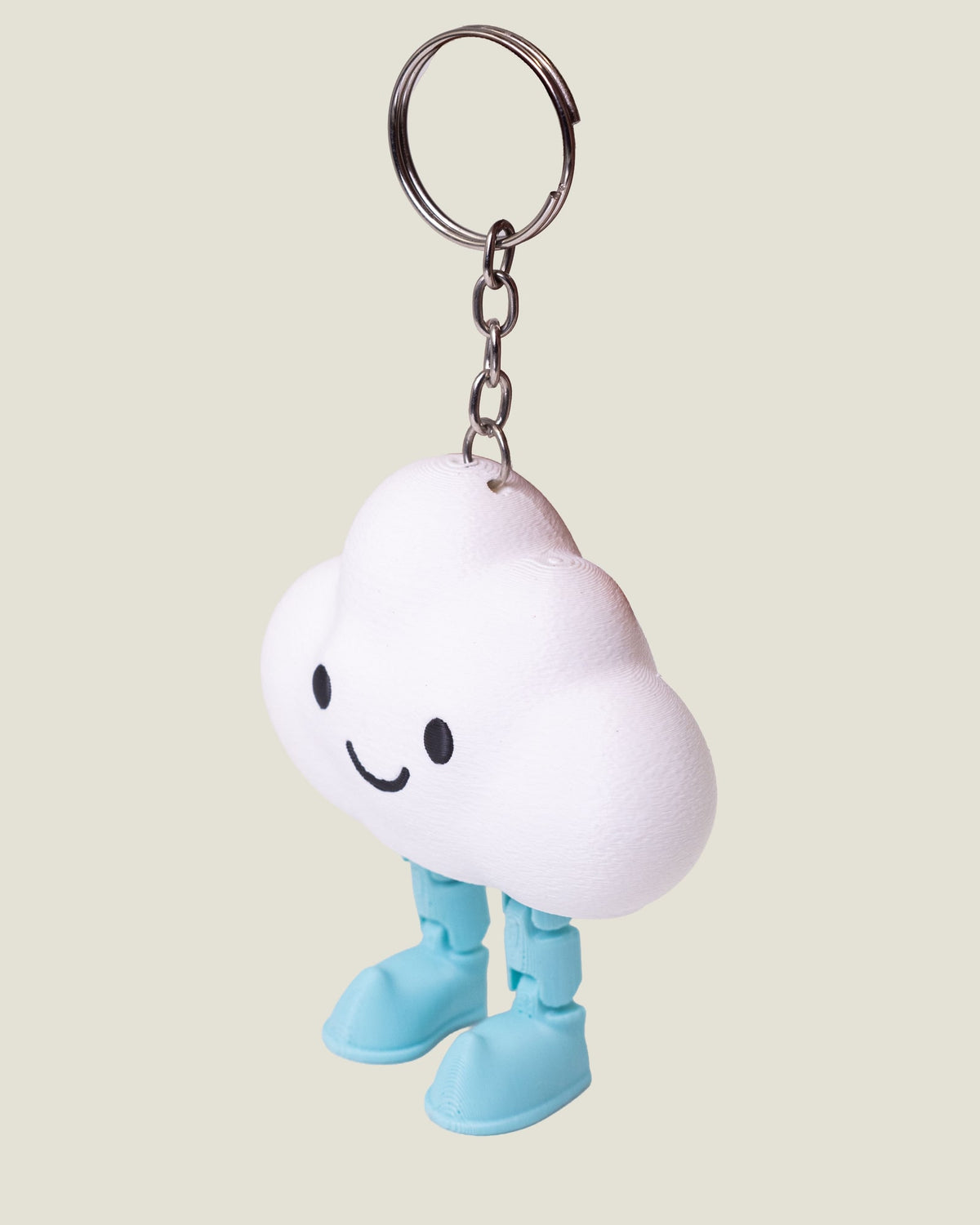 3D printed smiling cloud keychain with jiggly jointed legs