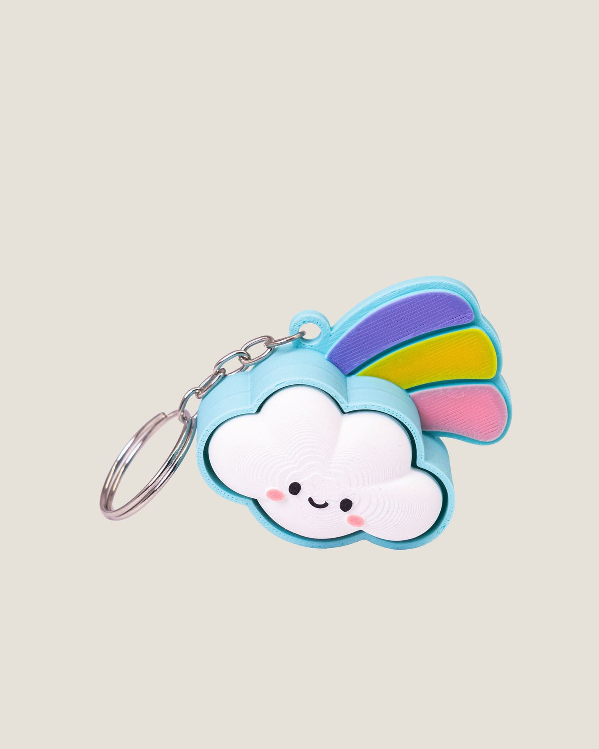3D printed smiling cloud keychain with a pastel rainbow