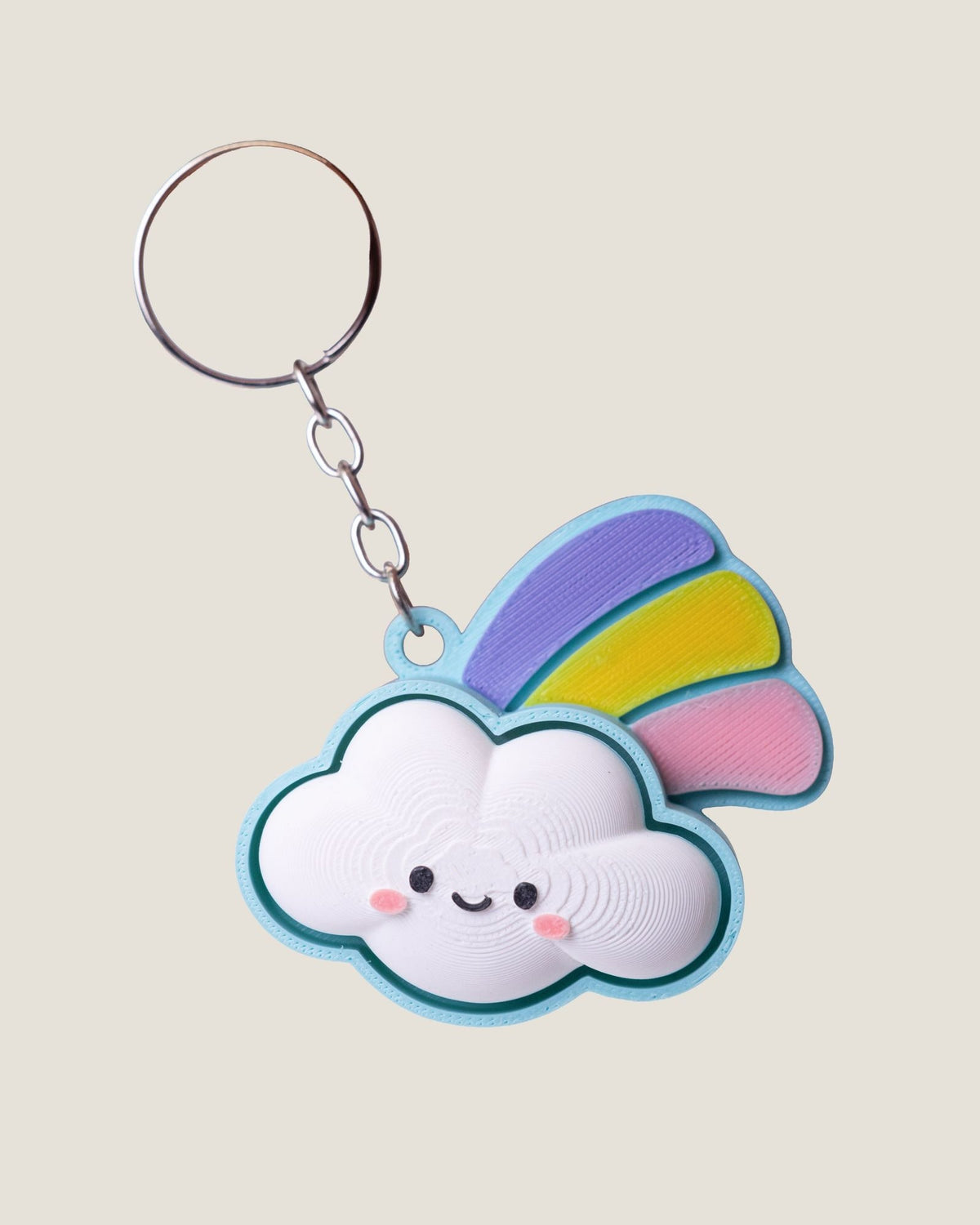 3D printed smiling cloud keychain with a pastel rainbow