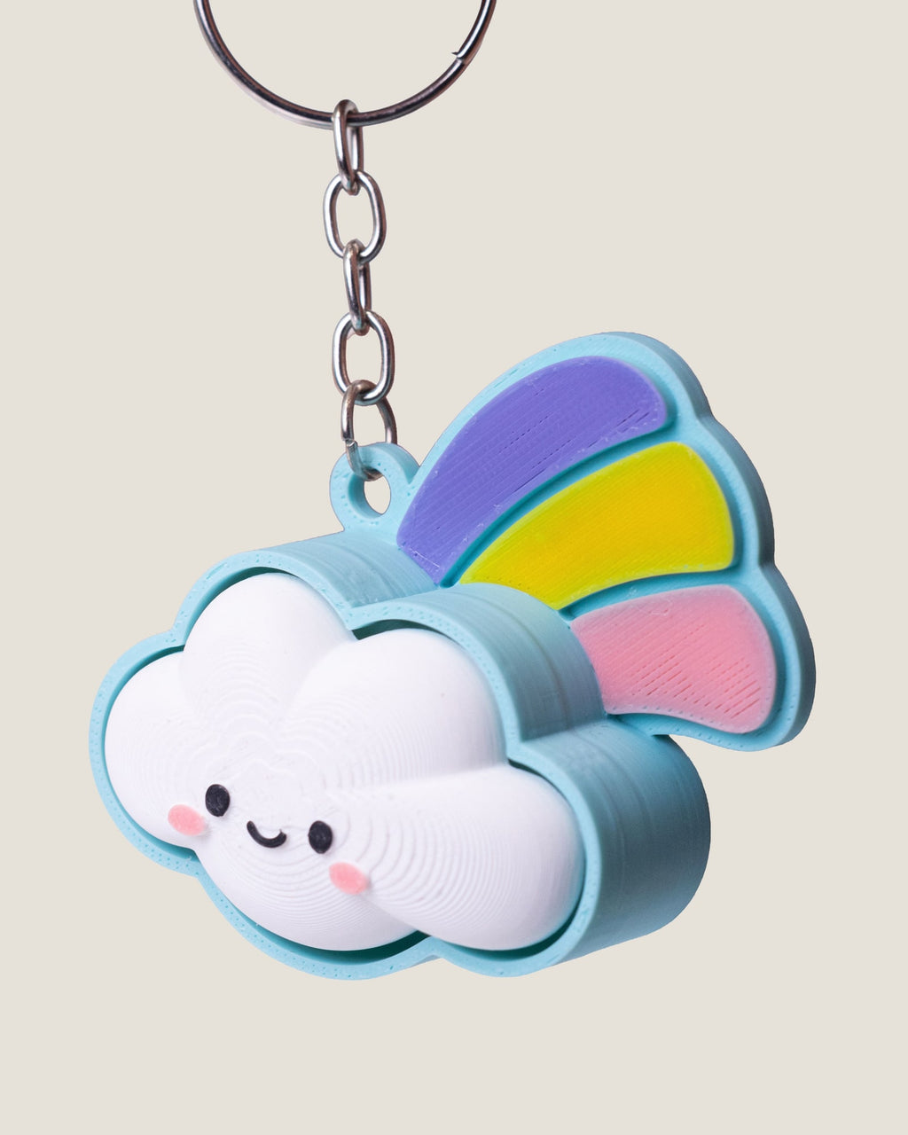 3D printed smiling cloud keychain with a pastel rainbow
