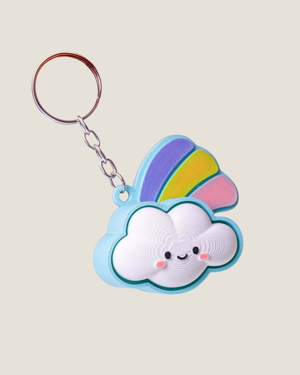 3D printed smiling cloud keychain with a pastel rainbow