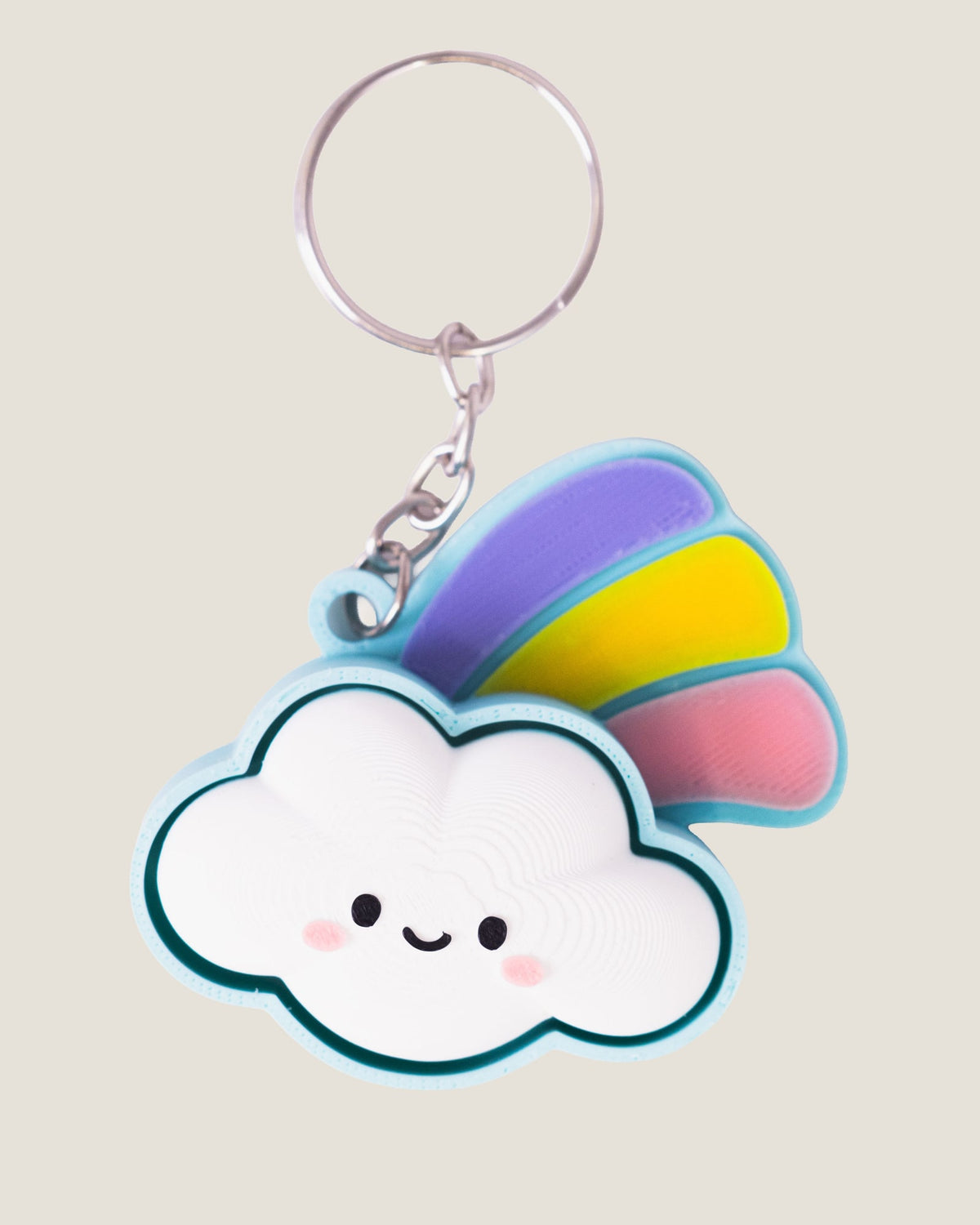 3D printed smiling cloud keychain with a pastel rainbow