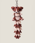 3D printed flexi puppy keychain with a long fluffy jointed tail