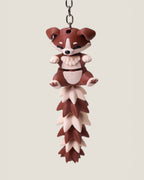 3D printed flexi puppy keychain with a long fluffy jointed tail