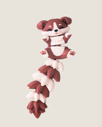 3D printed flexi puppy keychain with a long fluffy jointed tail