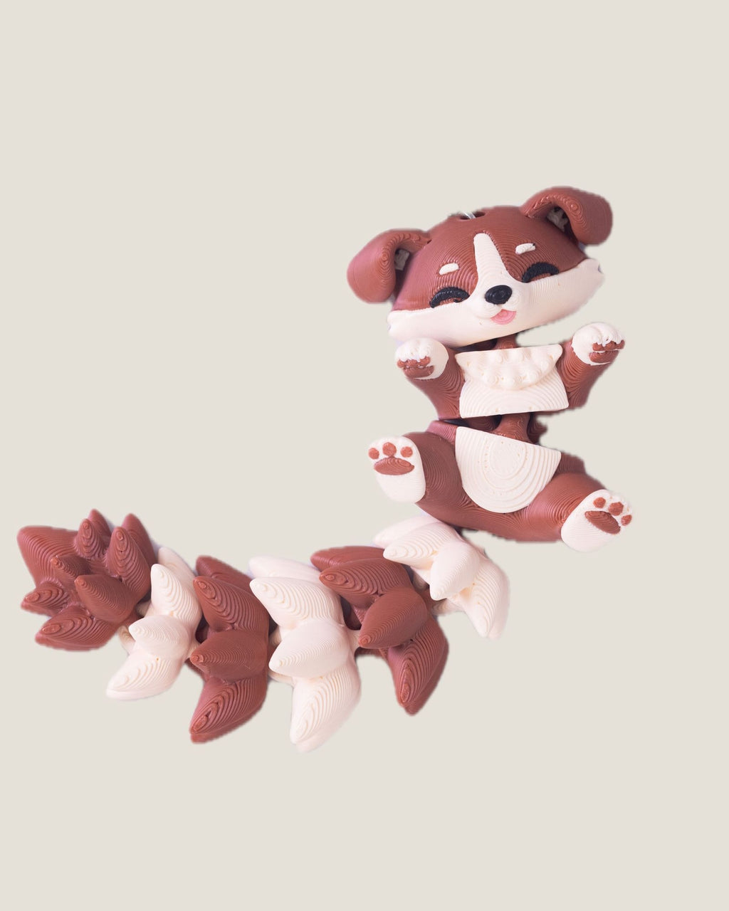 3D printed flexi puppy keychain with a long fluffy jointed tail