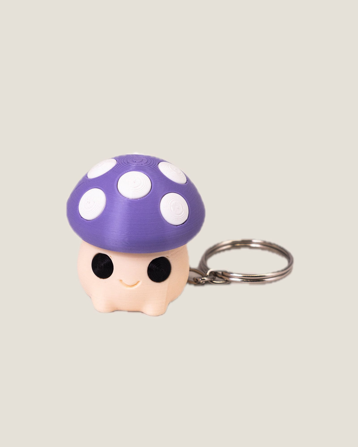 3D printed mushroom clicker keychains in purple, red and pink
