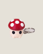 3D printed mushroom clicker keychains in purple, red and pink