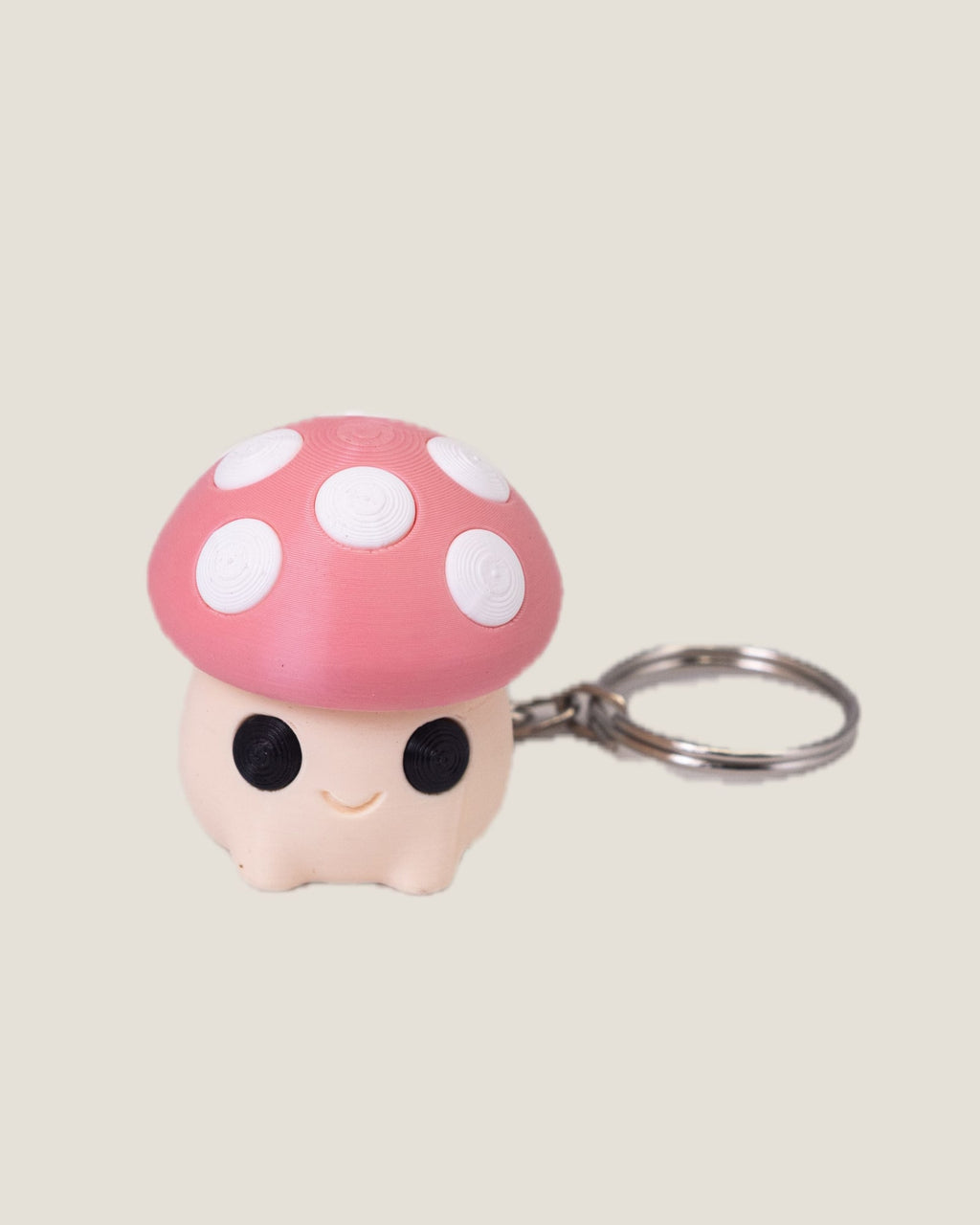 3D printed mushroom clicker keychains in purple, red and pink