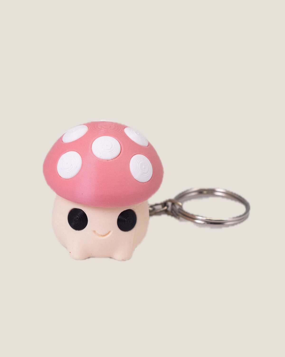 3D printed mushroom clicker keychains in purple, red and pink