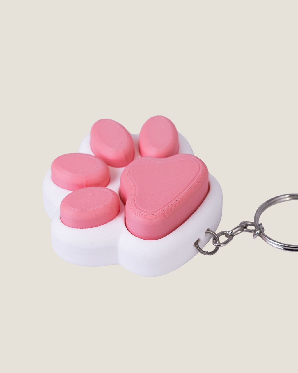 3D printed pink cat paw clicker keychain