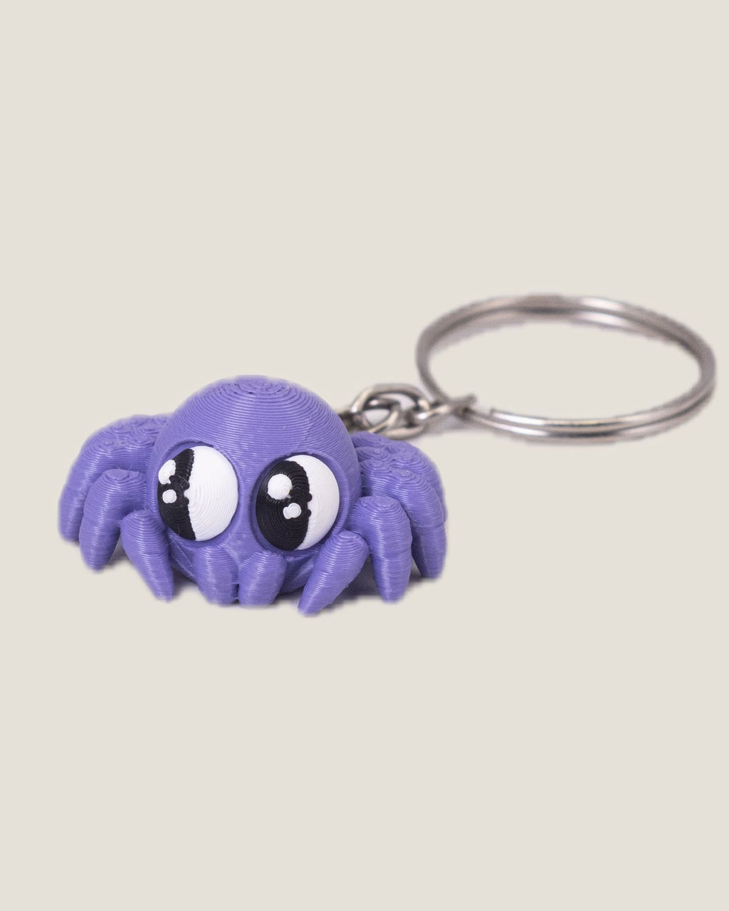 3D printed purple jiggly spider keychain with big eyes