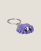 3D printed purple jiggly spider keychain with big eyes