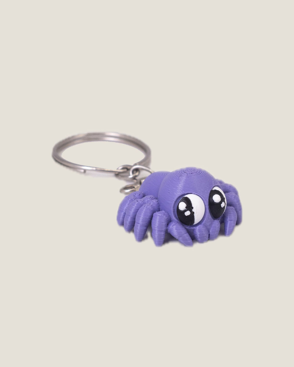 3D printed purple jiggly spider keychain with big eyes