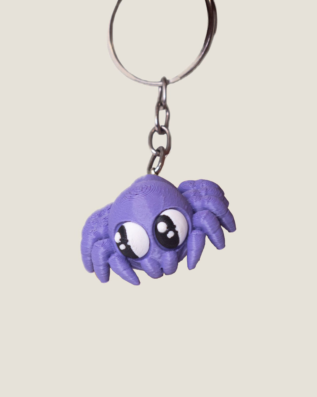 3D printed purple jiggly spider keychain with big eyes